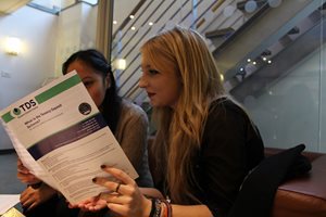 Two women reading a TDS Deposit Booklet